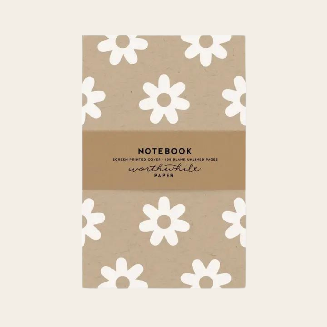 Unlined eco friendly notebook with white daisy pattern on a kraft background