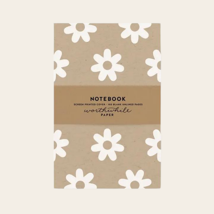 Unlined eco friendly notebook with white daisy pattern on a kraft background