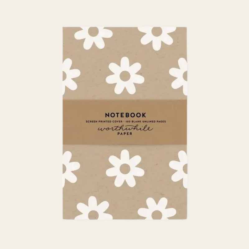 Unlined eco friendly notebook with white daisy pattern on a kraft background