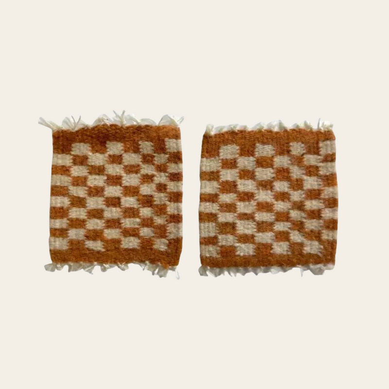 Handwoven checkered orange and cream wool coasters made in Oaxaca, Mexico