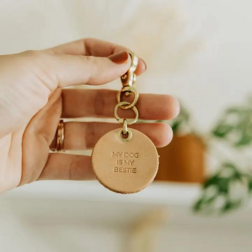 Vegetable tanned leather keychain with brass hardware that says "My Dog is My Bestie"