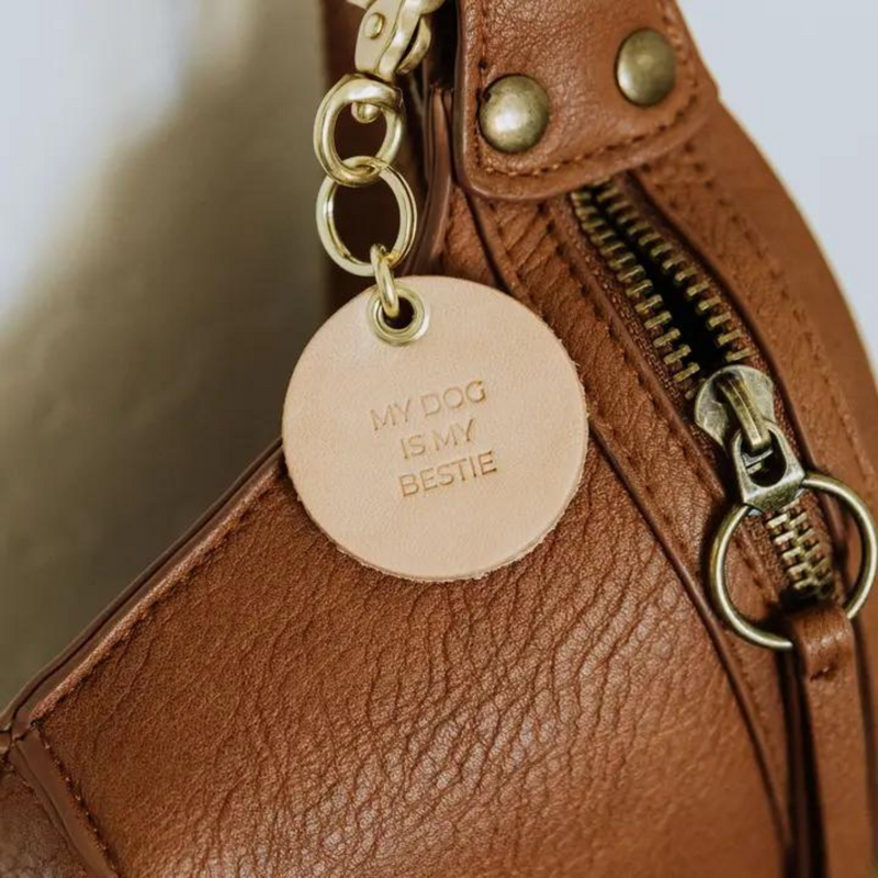 Vegetable tanned leather keychain with brass hardware that says "My Dog is My Bestie" on purse