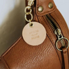 Vegetable tanned leather keychain with brass hardware that says "My Dog is My Bestie" on purse