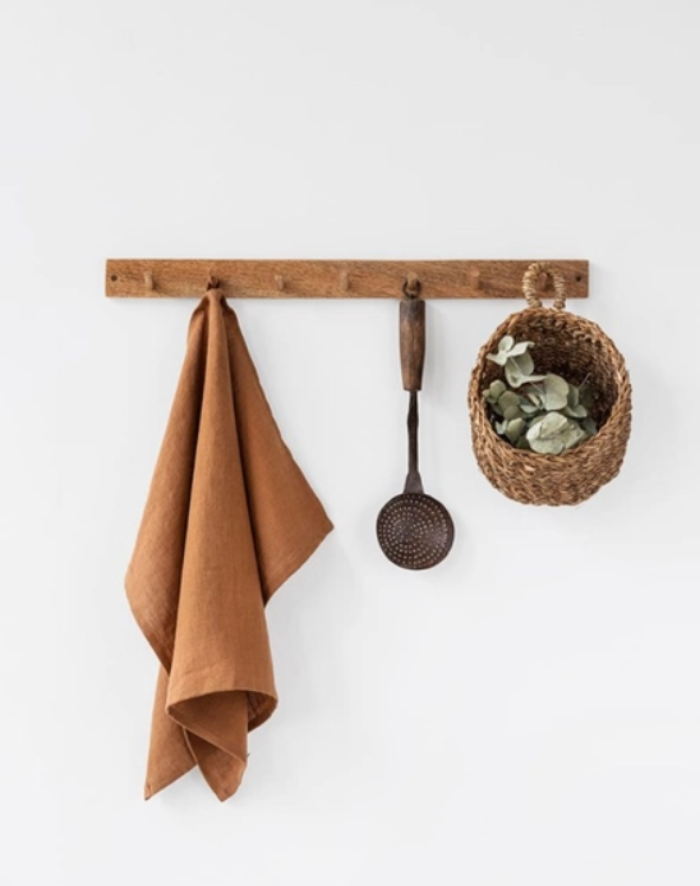 Hanging towel on wooden wall rack